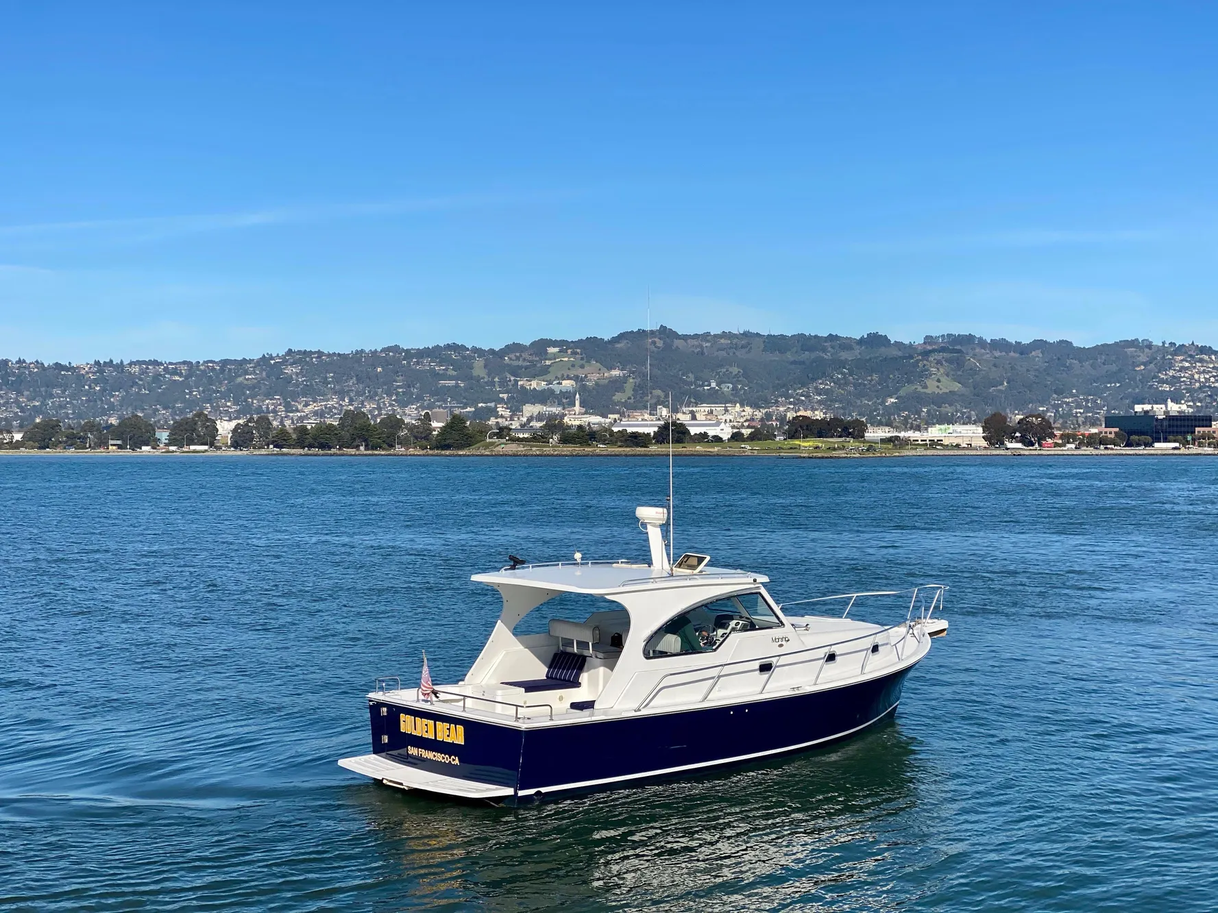 2000 Mainship Pilot 34 boat cruising on calm waters.