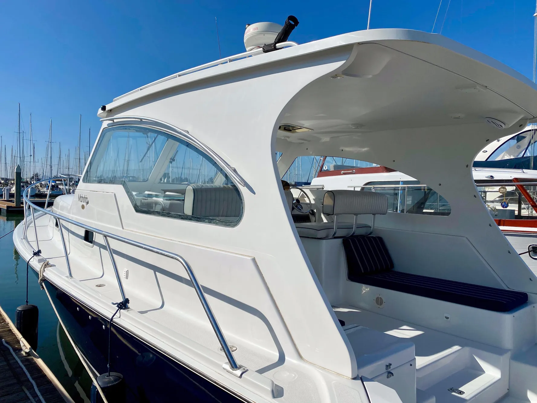2000 Mainship Pilot 34 boat docked in marina.