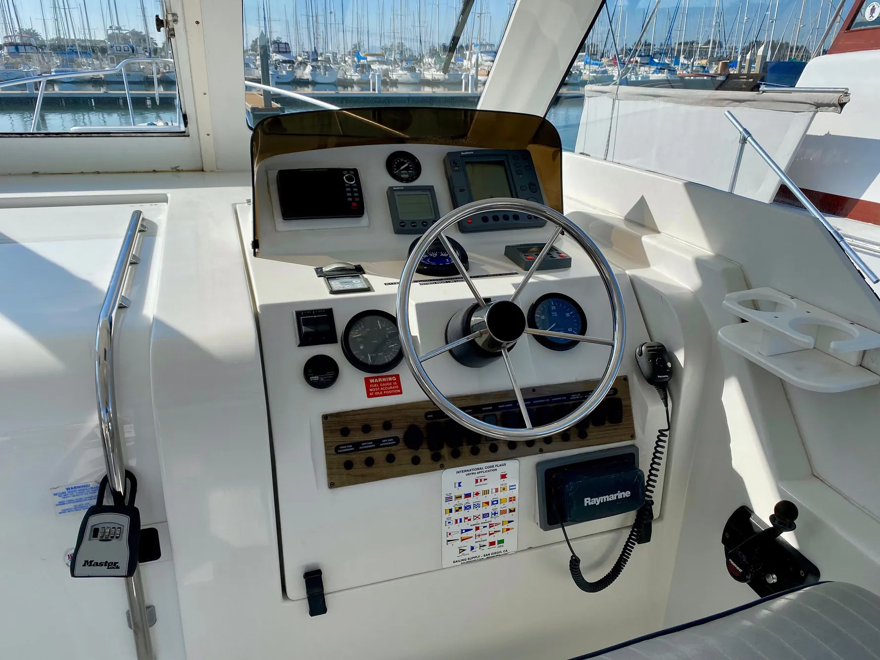 Helm of a 2000 Mainship Pilot 34 yacht in harbor.