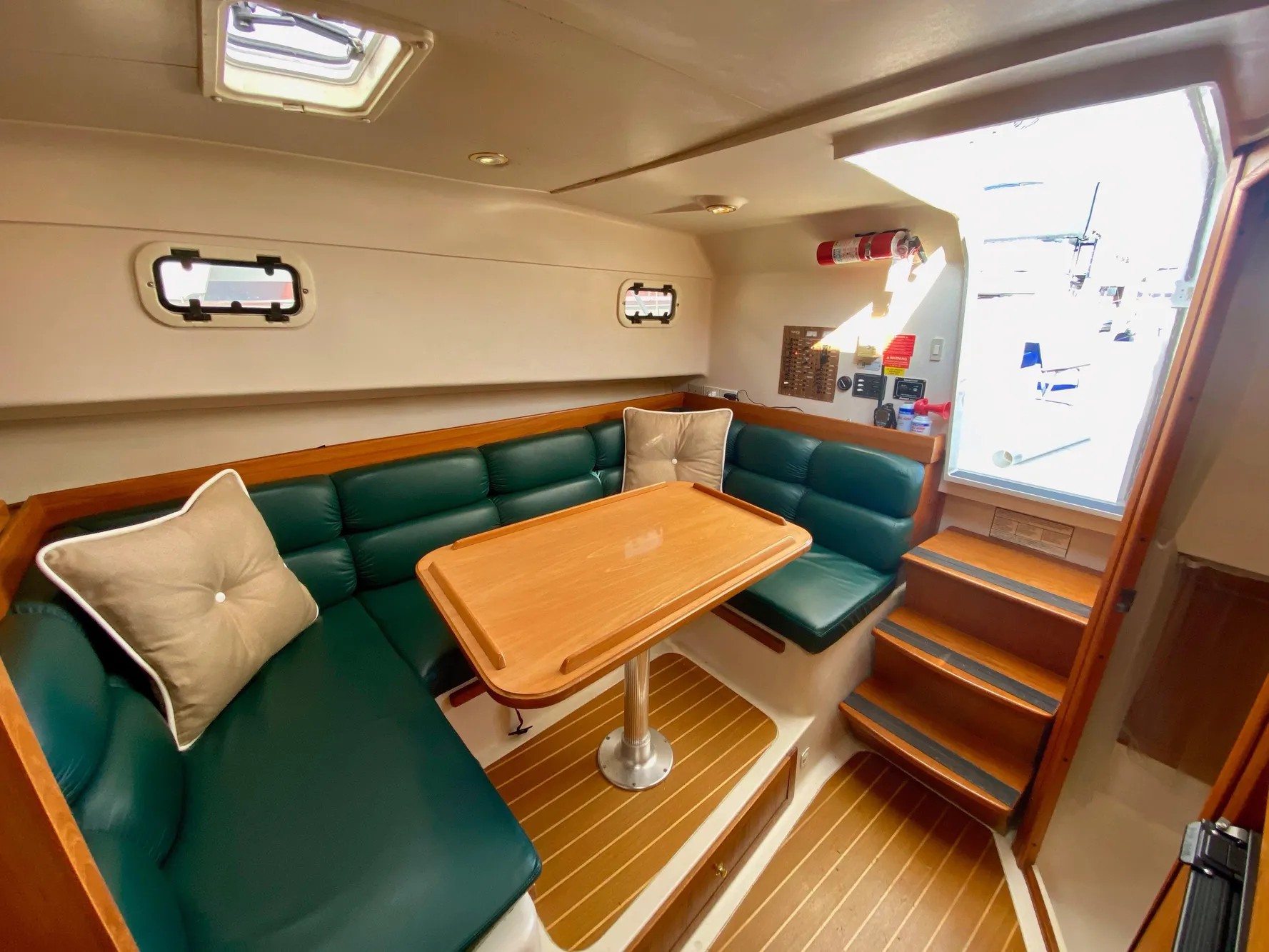 Interior of a 2000 Mainship Pilot 34 yacht with green upholstery.