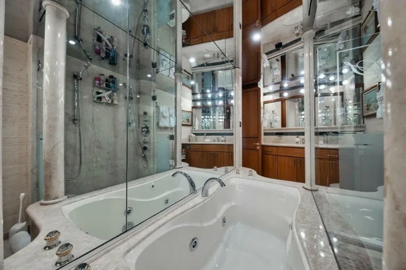Island Girl Yacht Photos Pics Luxurious bathroom with marble jacuzzi and mirrored walls on 2002 Westport 112 yacht.