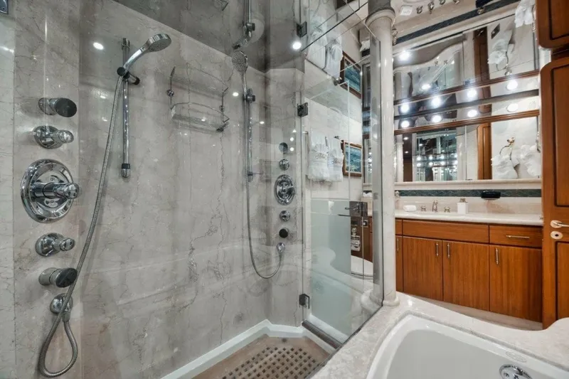 Island Girl Yacht Photos Pics Luxurious bathroom with marble shower and wooden cabinetry on a 2002 Westport 112 yacht.