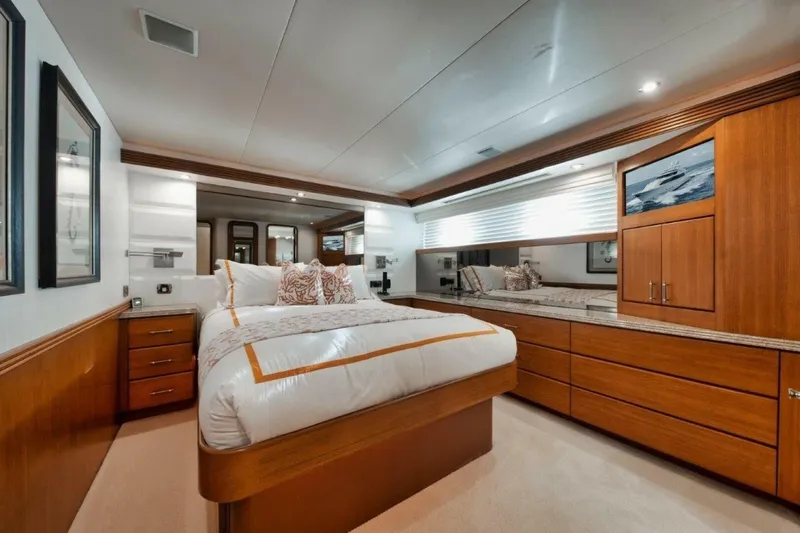 Island Girl Yacht Photos Pics Luxurious bedroom interior of 2002 Westport 112 yacht with elegant wood furnishings.