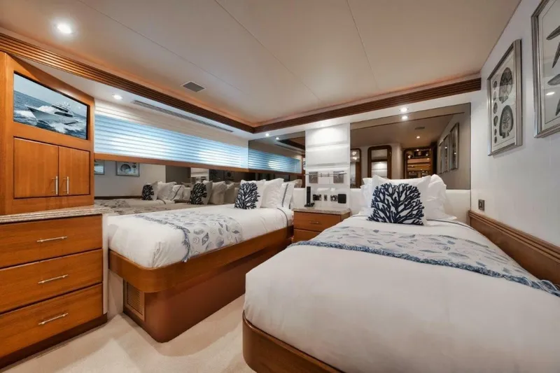 Island Girl Yacht Photos Pics Luxurious twin bedroom on 2002 Westport 112 yacht, featuring elegant decor and modern amenities.