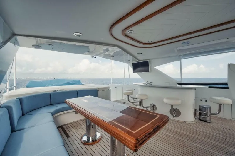 Island Girl Yacht Photos Pics Luxurious 2002 Westport 112 yacht interior with seating, table, and ocean view.