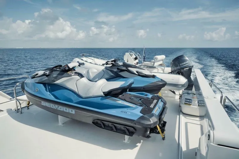 Island Girl Yacht Photos Pics Two Sea-Doo jet skis on a 2002 Westport 112 yacht deck, cruising on open water.