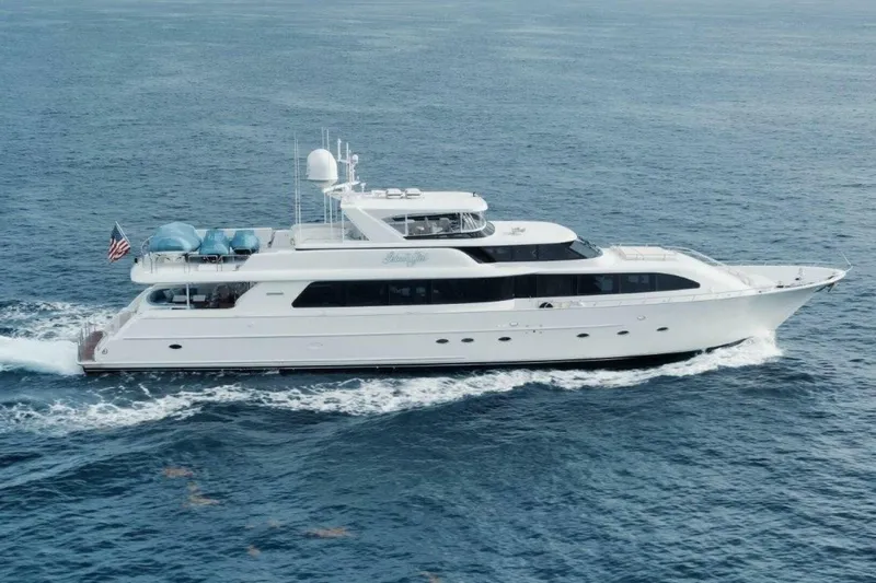 Island Girl Yacht Photos Pics Luxury 2002 Westport 112 yacht cruising on open sea, displaying sleek design and elegance.