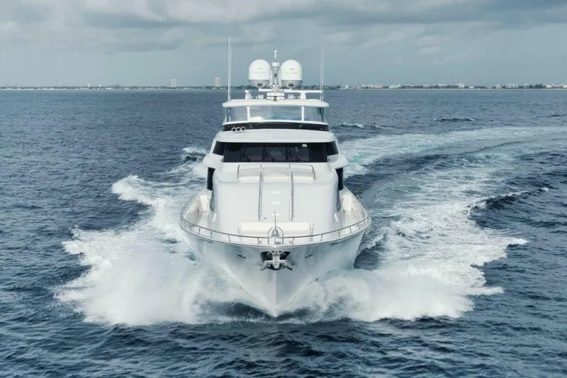 Island Girl Yacht Photos Pics Luxurious 2002 Westport 112 yacht cruising on open sea under cloudy skies.