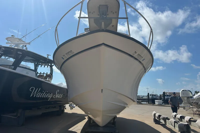  Yacht Photos Pics 2004 Grady-White Marlin 300 boat docked under a clear blue sky.