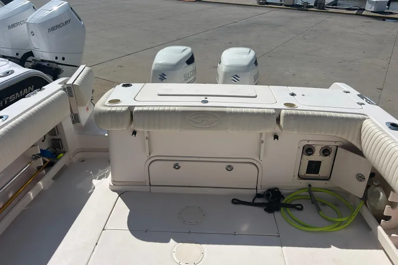  Yacht Photos Pics 2004 Grady-White Marlin 300 boat deck with dual outboard engines and storage compartments.