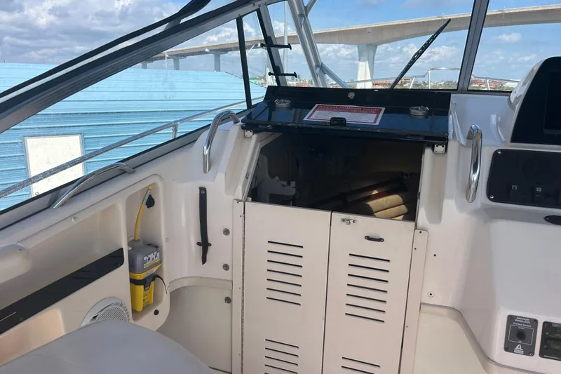  Yacht Photos Pics 2004 Grady-White Marlin 300 boat interior with storage compartment and control panel.