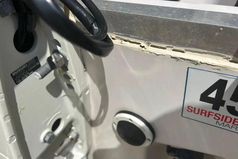  Yacht Photos Pics Close-up of a 2004 Grady-White Marlin 300 boat with visible Suzuki engine details.