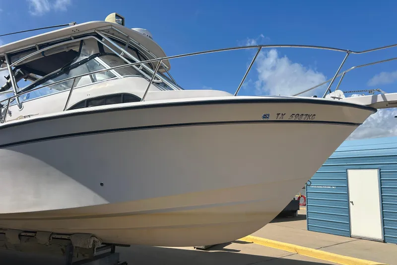  Yacht Photos Pics 2004 Grady-White Marlin 300 boat on trailer, clear sky background.