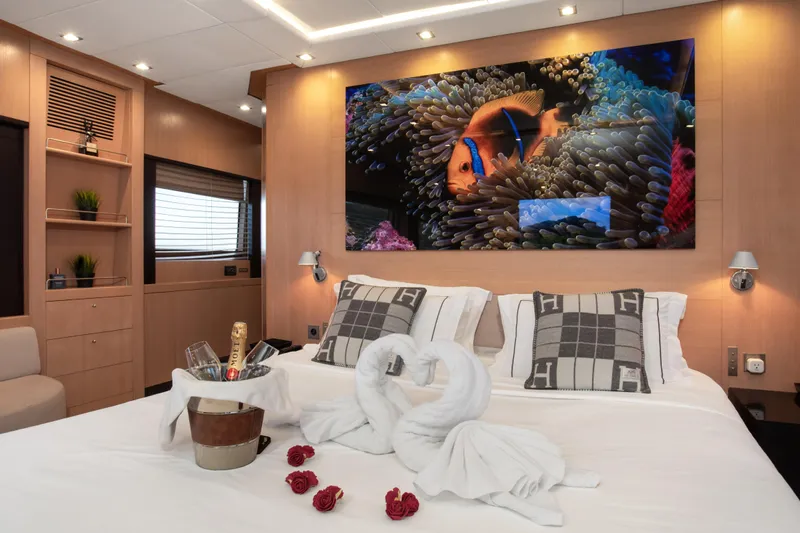 My Mr J Yacht Photos Pics Luxurious yacht bedroom with elegant decor, featuring swan towels and champagne, ISA 120, 2006.