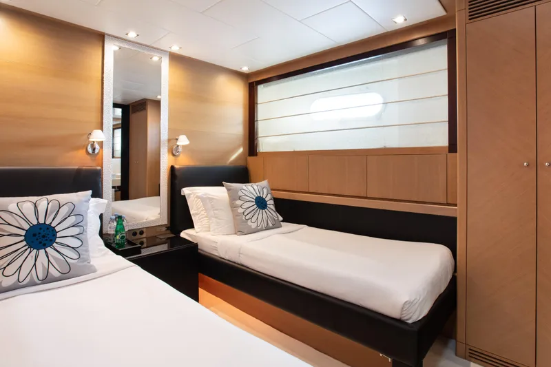 My Mr J Yacht Photos Pics Luxurious cabin interior of 2006 ISA 120 yacht with twin beds and floral pillows.