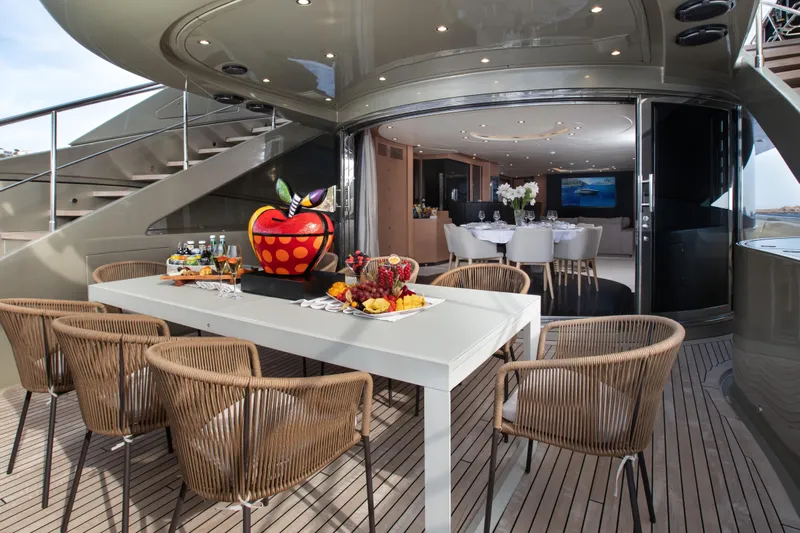 My Mr J Yacht Photos Pics Luxurious yacht deck with dining area, modern decor, and fruit centerpiece, ISA 120, 2006 model.