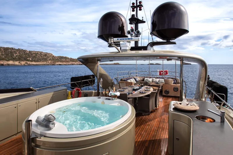 My Mr J Yacht Photos Pics Luxurious 2006 ISA 120 yacht deck with jacuzzi, dining area, and ocean view.