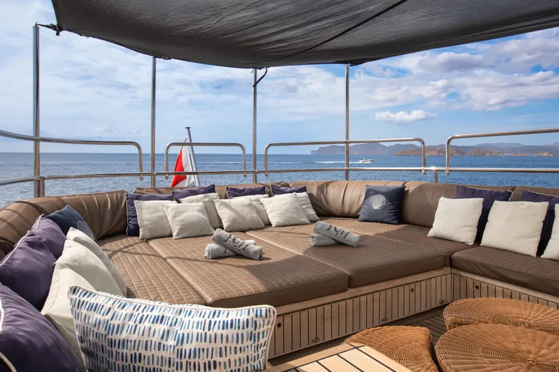 My Mr J Yacht Photos Pics Luxurious seating area on 2006 ISA 120 yacht with ocean view and cushions.