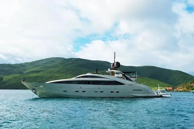 My Mr J Yacht Photos Pics Luxury ISA 120 yacht from 2006 on serene waters with lush green hills.