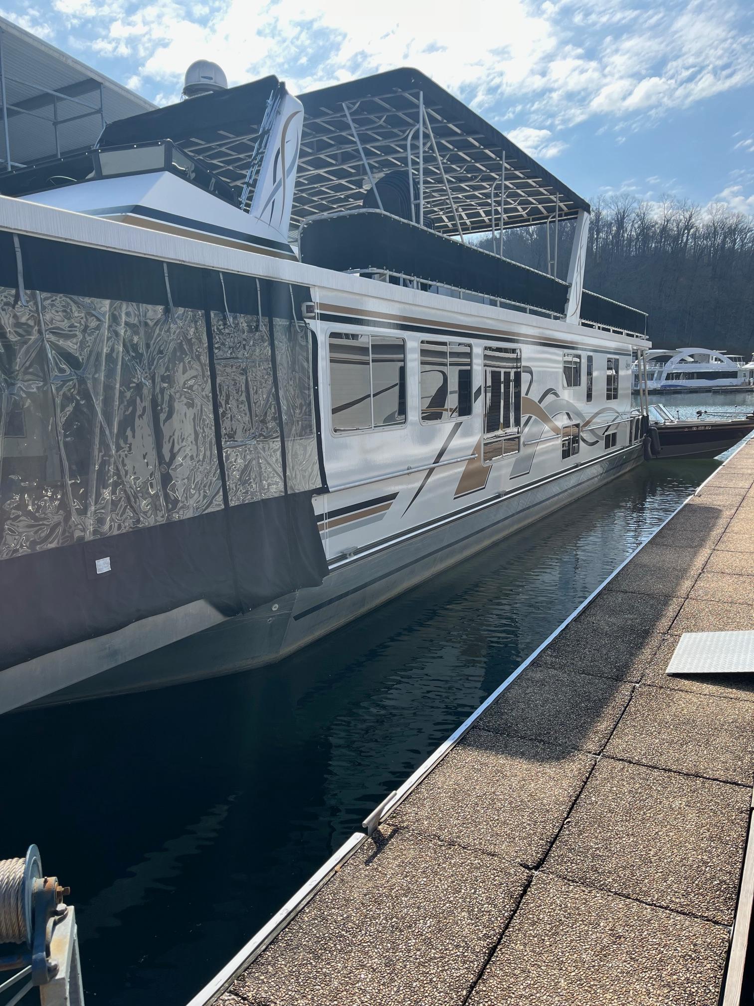 2003 Lakeview Houseboat docked at a marina on a sunny day.