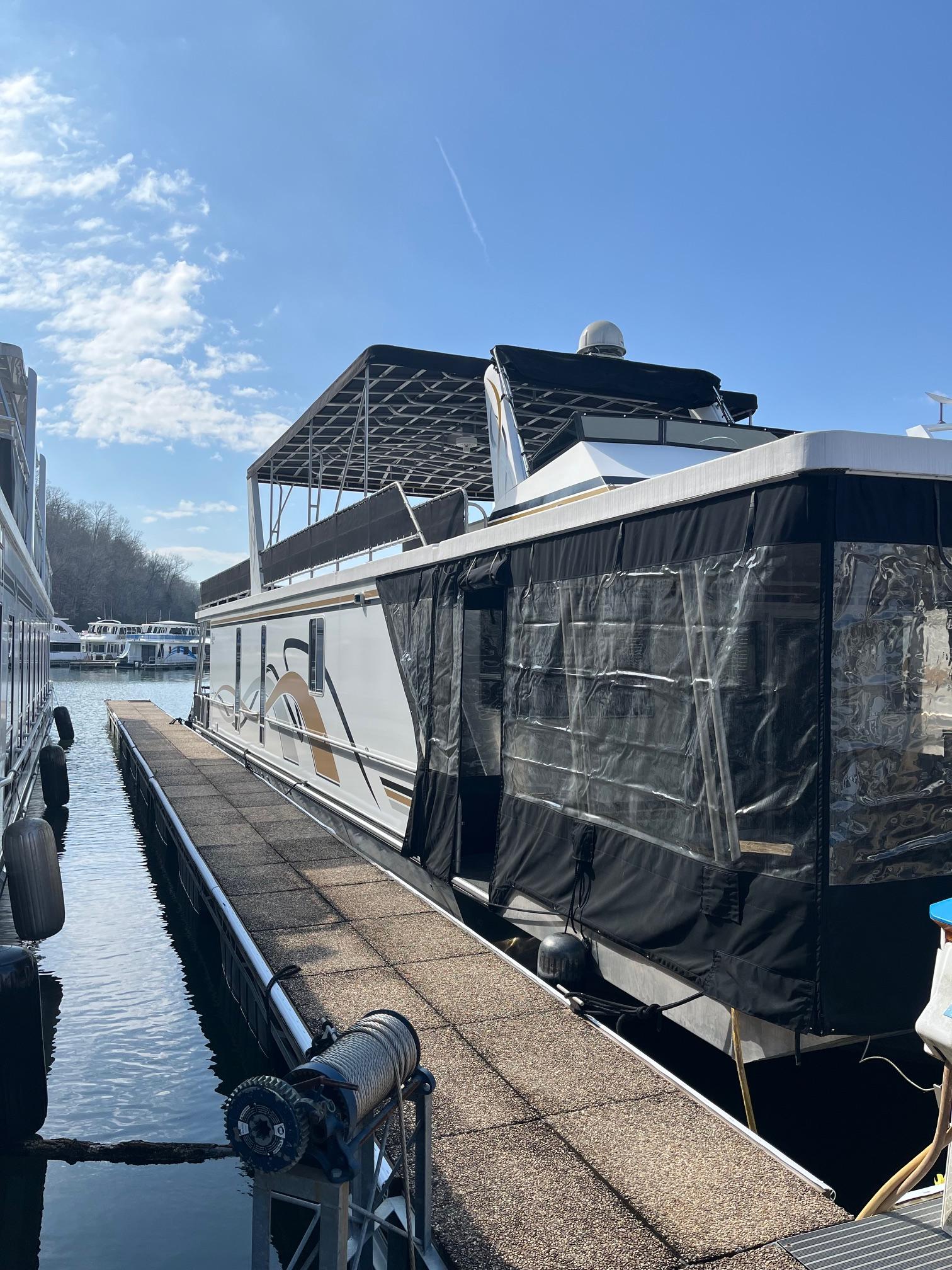 2003 Lakeview Houseboat docked at a marina on a sunny day.