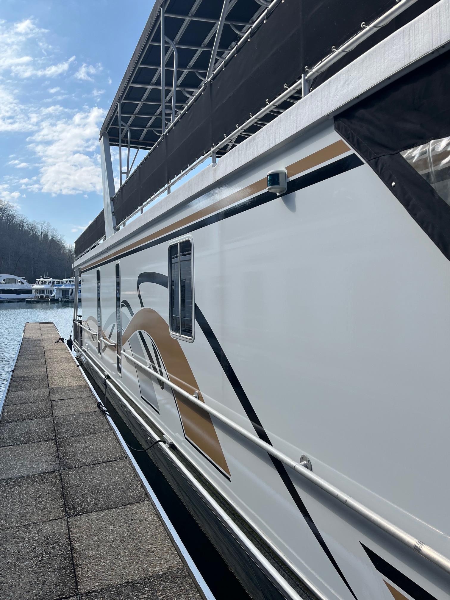 2003 Lakeview Houseboat docked at a marina on a sunny day.