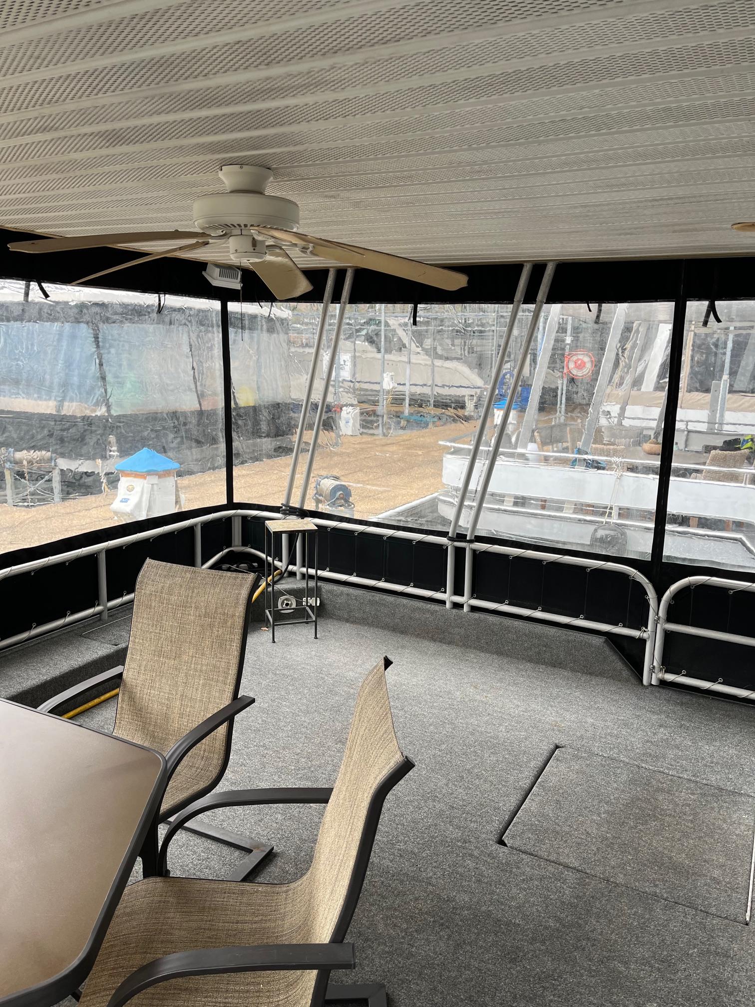 2003 Lakeview Houseboat interior with dining area and ceiling fan.