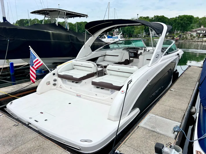  Yacht Photos Pics 2016 Regal 3200 Bowrider boat docked, featuring spacious seating and American flag.