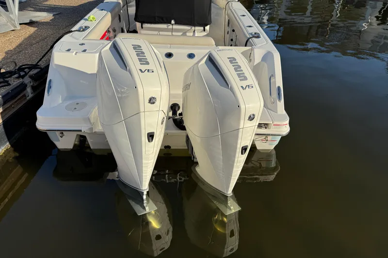  Yacht Photos Pics 2023 Boston Whaler 250 Outrage with dual Mercury V6 engines docked in water.