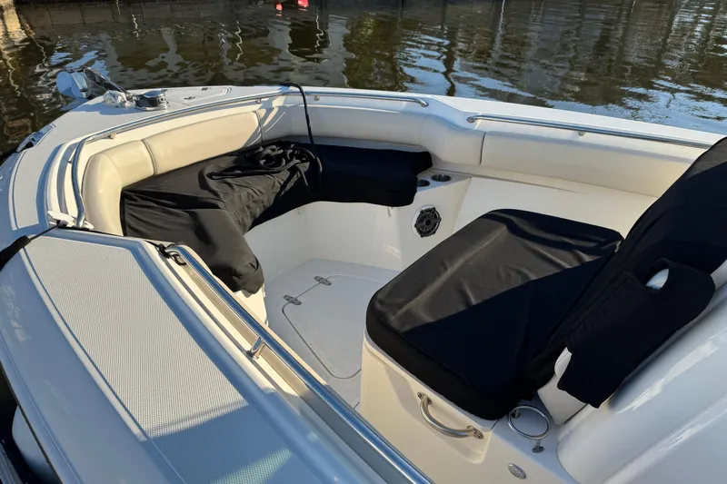  Yacht Photos Pics 2023 Boston Whaler 250 Outrage boat interior with cushioned seating and cup holders.