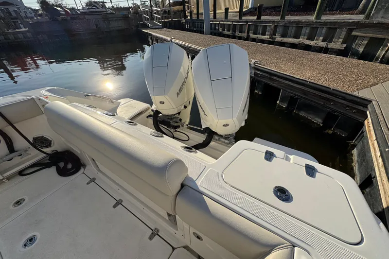  Yacht Photos Pics 2023 Boston Whaler 250 Outrage boat with dual Mercury engines docked by the water.