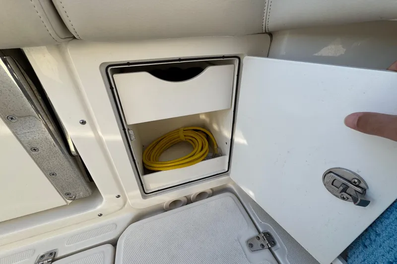 Yacht Photos Pics Storage compartment on 2023 Boston Whaler 250 Outrage boat with yellow cable inside.