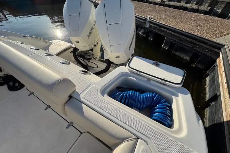  Yacht Photos Pics 2023 Boston Whaler 250 Outrage boat with Mercury engines and coiled blue hose.