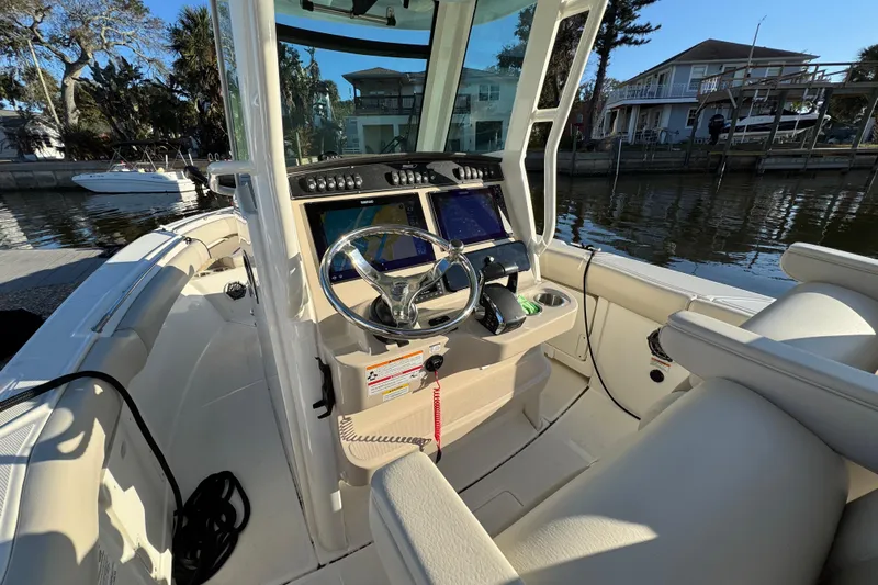  Yacht Photos Pics 2023 Boston Whaler 250 Outrage boat interior with modern helm and steering wheel.