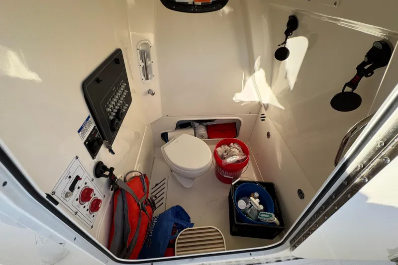  Yacht Photos Pics Interior of 2023 Boston Whaler 250 Outrage boat, featuring storage and control panel.