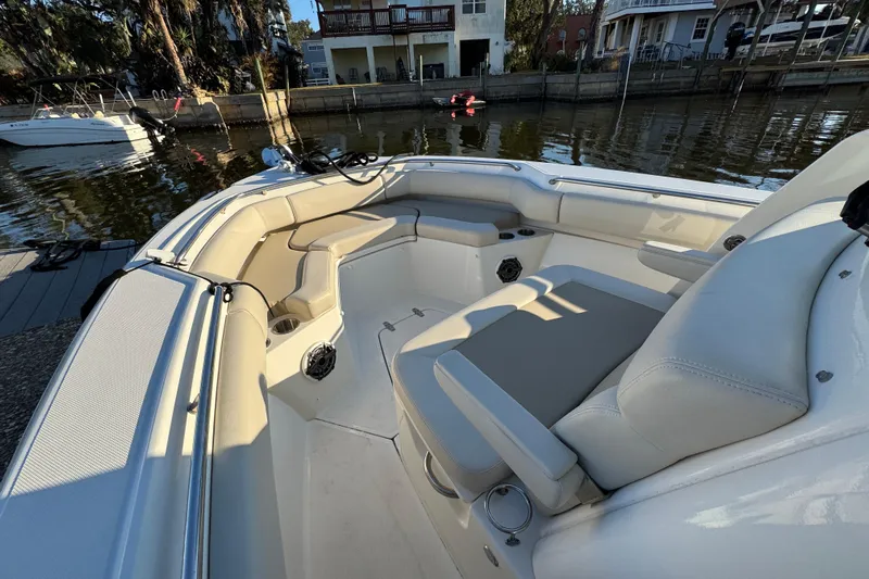  Yacht Photos Pics 2023 Boston Whaler 250 Outrage boat interior with seating and cup holders by the dock.