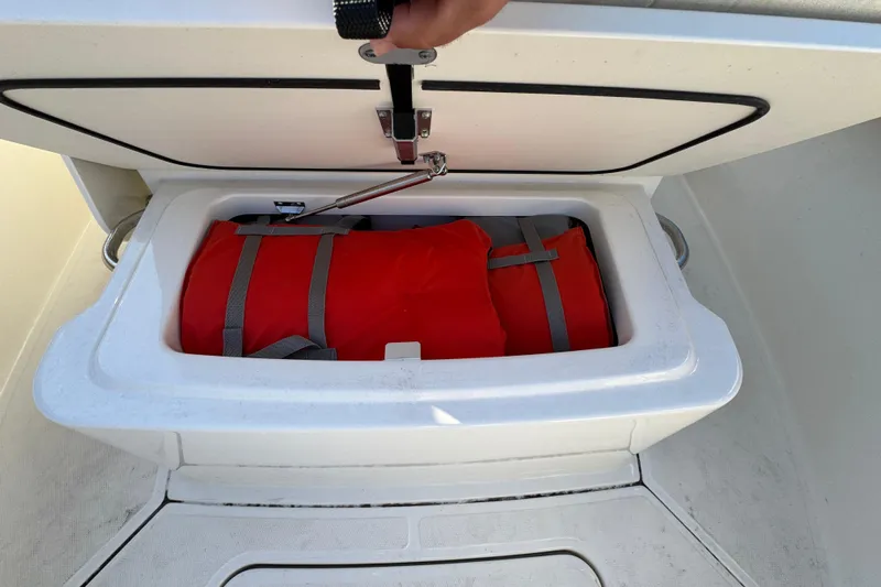  Yacht Photos Pics Storage compartment on 2023 Boston Whaler 250 Outrage with red life jacket inside.