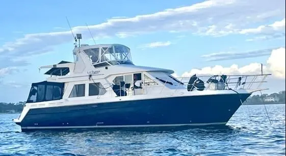 Lagypsie Yacht Photos Pics 1999 Navigator 4800 CLASSIC yacht on calm water under a partly cloudy sky.