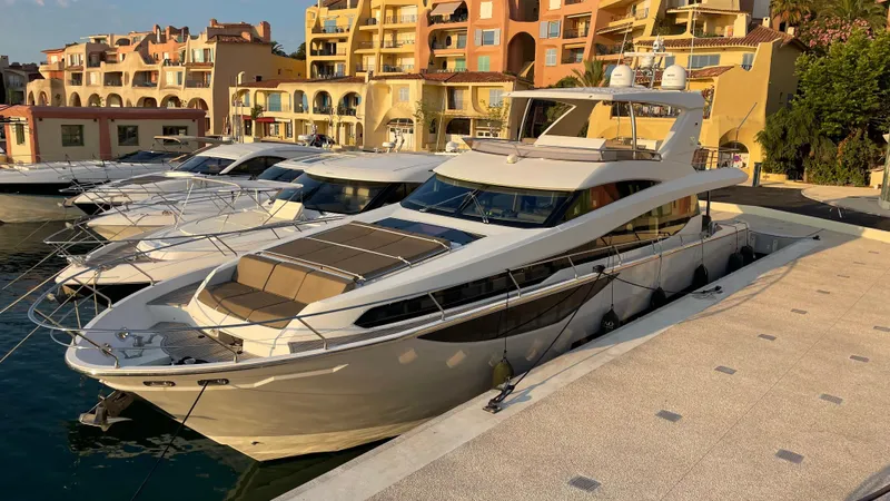 Tao Yacht Photos Pics Luxurious 2015 Prestige 750 yacht docked at a marina with scenic waterfront views.