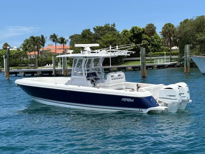 Agitator Yacht Photos Pics 2016 Intrepid 327 Center Console boat with Yamaha engines on clear blue water.