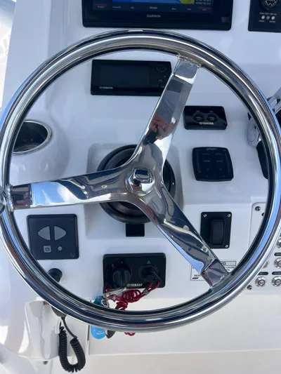 Agitator Yacht Photos Pics Steering wheel and controls of a 2016 Intrepid 327 Center Console boat.