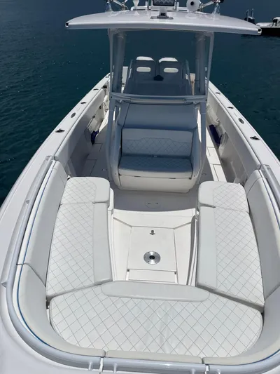 Agitator Yacht Photos Pics 2016 Intrepid 327 Center Console boat with spacious seating and sleek design on water.