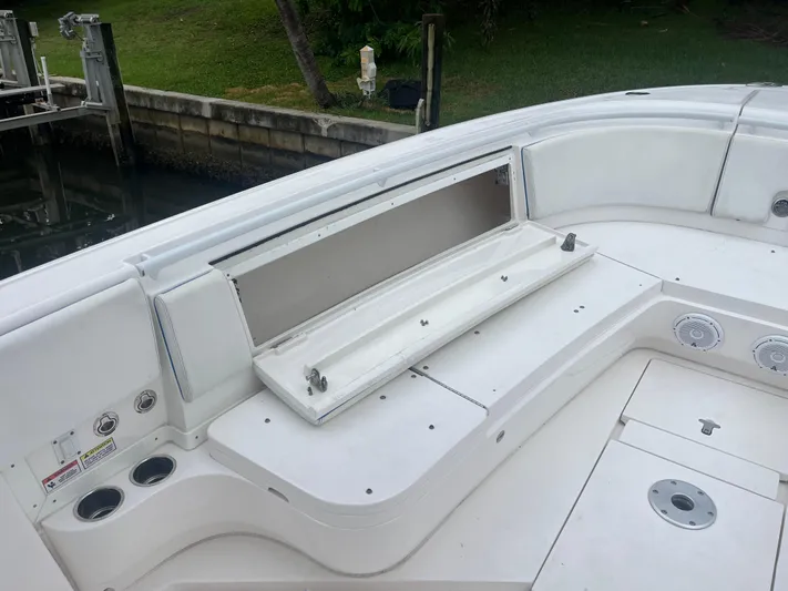 Agitator Yacht Photos Pics 2016 Intrepid 327 Center Console boat with open storage compartment and cup holders.