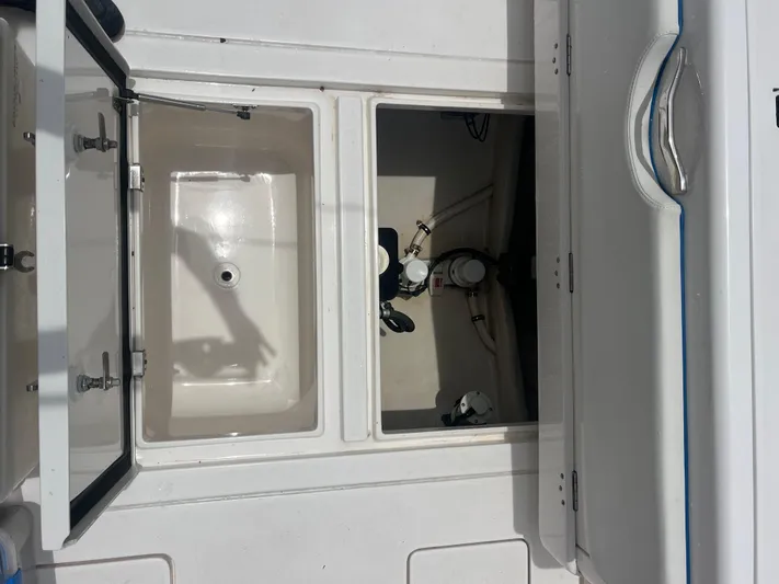 Agitator Yacht Photos Pics Open compartments on a 2016 Intrepid 327 Center Console boat deck.