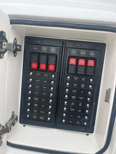 Agitator Yacht Photos Pics Electrical panel of a 2016 Intrepid 327 Center Console boat, featuring labeled switches.