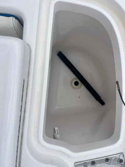 Agitator Yacht Photos Pics 2016 Intrepid 327 Center Console boat compartment with black rod inside.