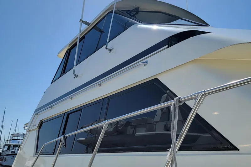 Southern Girl Yacht Photos Pics 1989 Hatteras Convertible yacht with sleek design and large windows, docked under clear sky.