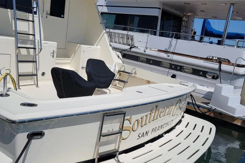 Southern Girl Yacht Photos Pics 1989 Hatteras Convertible yacht docked, featuring spacious deck and seating, named "Southern Girl."