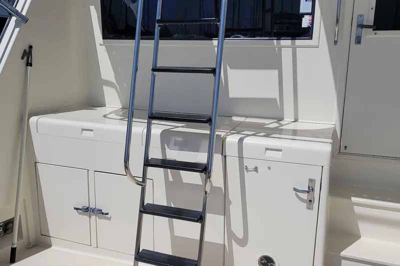 Southern Girl Yacht Photos Pics 1989 Hatteras Convertible boat ladder and storage compartments in sunlight.