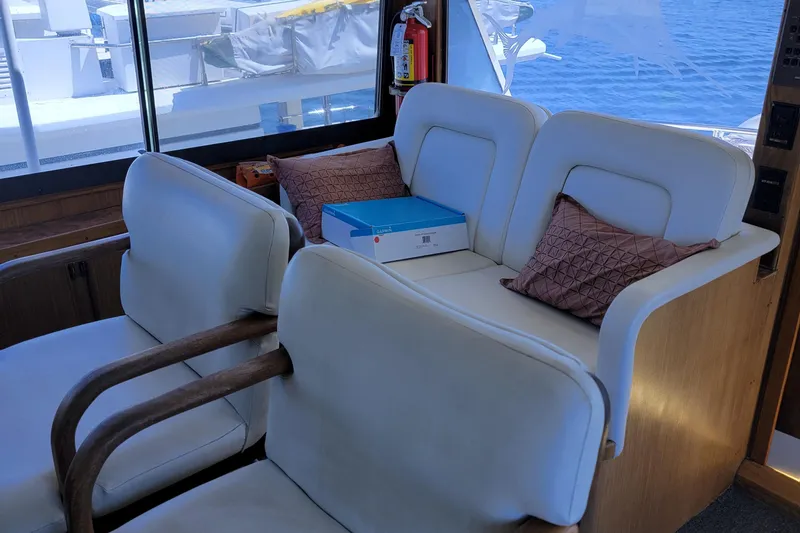 Southern Girl Yacht Photos Pics Interior of 1989 Hatteras Convertible yacht with white seating and decorative pillows.